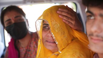 Pakistani citizen Sarita Kanwer consoles her mother, Priya Kanwer, who is an Indian citizen and who couldn't accompany Sarita and her father, as they prepare to leave India after India revoked visas issued to Pakistani citizens, at the Attari-Wagah border crossing near Amritsar, April 27, 2025. Reuters
