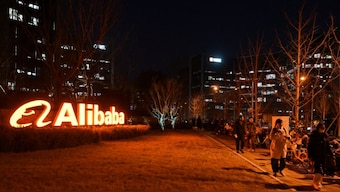 People walk past Alibaba’s offices in Beijing on February 14, 2025. AFP