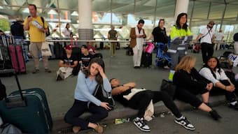 Passengers wait outside Atocha train station during a nationwide power outage in Madrid. AP
