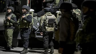 Indian army personnel stand guard near Pahalgam, south of Srinagar, following an attack. At least 26 people were killed when gunmen opened fire on tourists. AFP