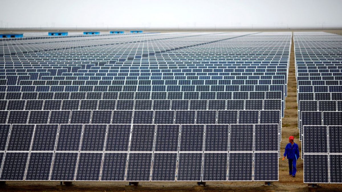 A worker inspects solar panels at a solar farm in Dunhuang, 950km (590 miles) northwest of Lanzhou, Gansu Province September 16, 2013. A worker inspects solar panels at a solar farm in Dunhuang, 950km (590 miles) northwest of Lanzhou, Gansu Province September 16, 2013.