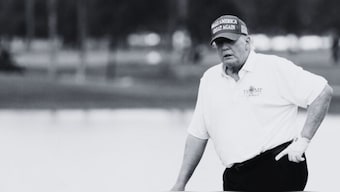 Oct 27, 2022; Miami, Florida, USA; Former President Donald Trump stands on the 18th green during the Pro-Am tournament before the LIV Golf series at Trump National Doral. Source: Reuters