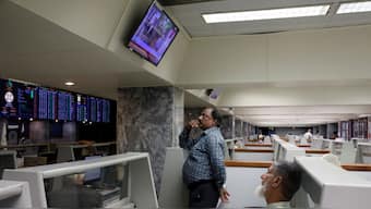 Stock brokers monitor new on television screen at a booth, during a trading session at the Pakistan Stock Exchange, in Karachi, Pakistan July 3, 2023. Source: Reuters