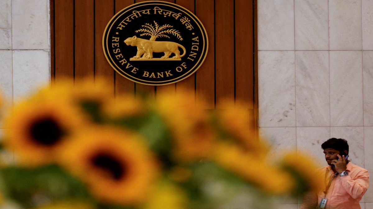 A man speaks on his phone as he walks past the Reserve Bank of India (RBI) logo inside its headquarters in Mumbai. File image/Reuters A man speaks on his phone as he walks past the Reserve Bank of India (RBI) logo inside its headquarters in Mumbai. File image/Reuters
