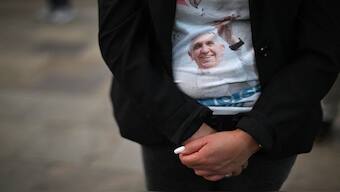 A woman wearing a T-shirt with an image of the late Pope Francis attends a memorial mass at the Metropolitan Cathedral in Guatemala City. On April 26, Pope Francis' funeral will take place at St Peter's Square in Vatican City. AFP