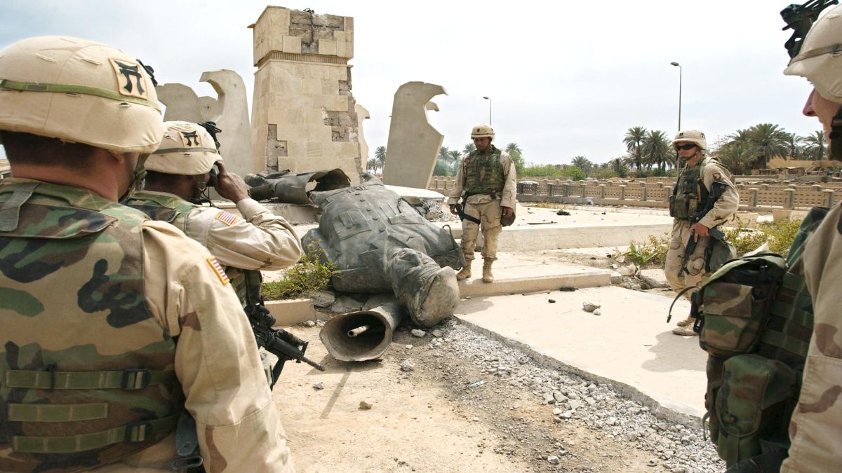 US soldiers from the 101st Airbone shoot a souvenir picture in front of a statue of toppled Iraqi leader Saddam Hussein lying on the ground after being blown up in Baghdad. File image/AFP US soldiers from the 101st Airbone shoot a souvenir picture in front of a statue of toppled Iraqi leader Saddam Hussein lying on the ground after being blown up in Baghdad. File image/AFP