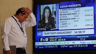 A man walks past a screen at the Bombay Stock Exchange (BSE) ahead of Trump's tariff plans, in Mumbai. (Photo: Reuters)