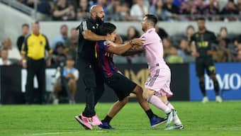 Yassine Cheuko intervenes as a fan approaches Lionel Messi during a match. Image: Reuters