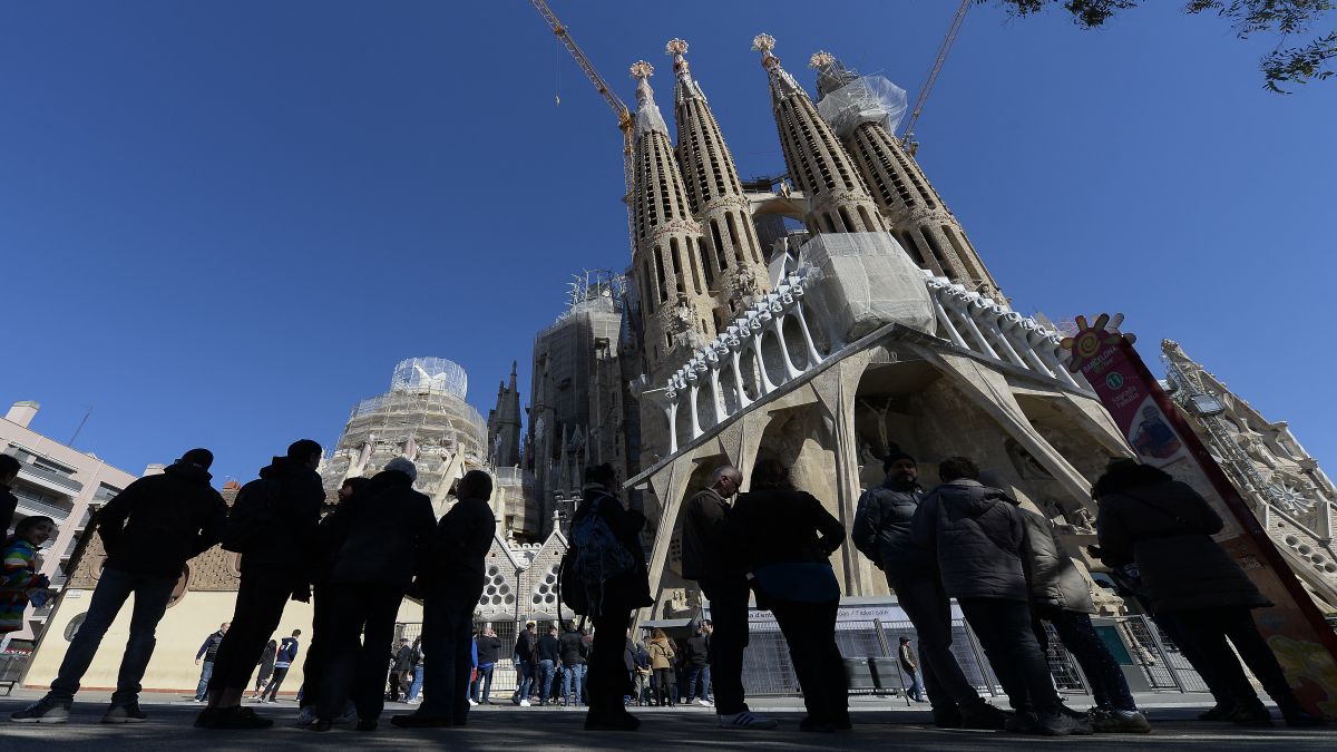 People wait in front of the Passion facade (Western side) of the Basilica and Expiatory Church of the Holy Family (Sagrada Familia) in Barcelona. The country has now ended its golden visa programme, starting today (April 3). File image/AFP People wait in front of the Passion facade (Western side) of the Basilica and Expiatory Church of the Holy Family (Sagrada Familia) in Barcelona. The country has now ended its golden visa programme, starting today (April 3). File image/AFP