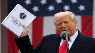 US President Donald Trump holds a "Foreign Trade Barriers" document as he delivers remarks on tariffs in the Rose Garden at the White House in Washington, DC. Reuters