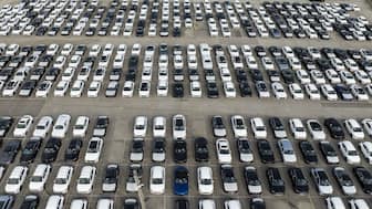 New vehicles are parked on the pier in Baltimore, Maryland. Experts note that India's auto sector will be relatively insulated from Trump's levies. File image/AFP