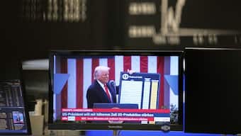 US President Donald Trump appears on a television screen at the stock market in Frankfurt, as he announces tariffs on April 2. The reciprocal tariffs on countries come into effect today (April 9). AP