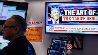 A trader works as a television screen shows news about US President Donald Trump's trade and tariff policies, on the floor of the New York Stock Exchange (NYSE) at the opening bell on April 10, in New York City. AFP