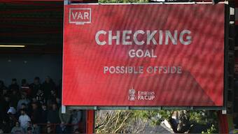 The big screen displays the news that a VAR review is ongoing in Premier League. Image: AFP