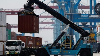 FILE PHOTO: A person operates a crane, loading a container onto a truck at Tanjung Priok Port in Jakarta, Indonesia, February 12, 2025. REUTERS/Willy Kurniawan/File Photo