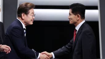 South Korea's presidential candidates Kim Moon-soo of the People Power Party shakes hands with Lee Jae-myung of the Democratic Party prepare for the second televised debate for the upcoming presidential election in Seoul, South Korea. Reuters