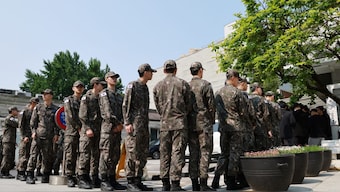 South Korean soldiers wait in a line to cast their early vote for the upcoming presidential election at a polling station in Seoul, South Korea. Reuters