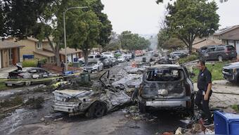 Investigators look through the site where a small plane crashed on a residential street in San Diego, California. AFP