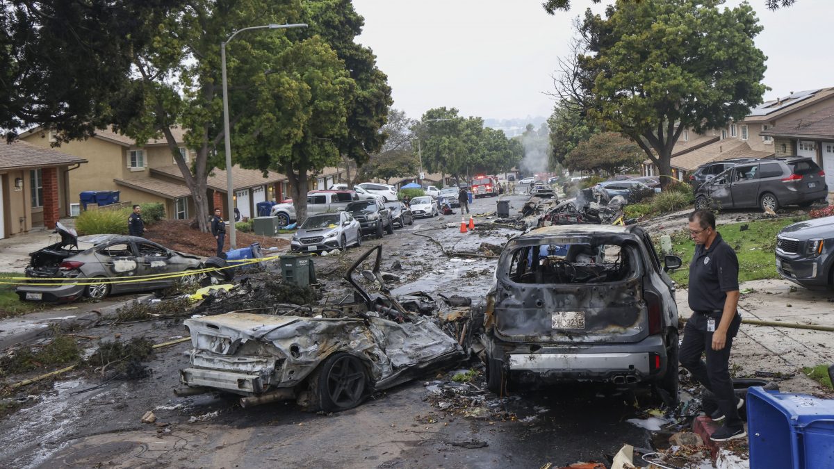 Investigators look through the site where a small plane crashed on a residential street in San Diego, California. AFP Investigators look through the site where a small plane crashed on a residential street in San Diego, California. AFP