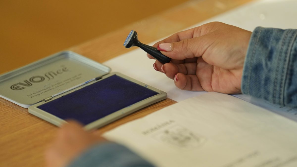 An election official holds a voting stamp during the first round of the presidential election redo in Bucharest, Romania. AP An election official holds a voting stamp during the first round of the presidential election redo in Bucharest, Romania. AP