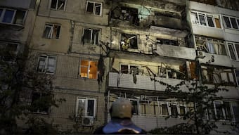 Emergency workers navigates his colleagues at the site of residential building damaged after a Russian attack in Kyiv, Ukraine. File Image / AP