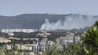 Smoke rises from a mountain in Pohang, South Korea, where a Navy patrol plane carrying four people crashed. AP