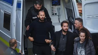 Andrew Tate and his brother Tristan Tate are escorted by police officers outside the headquarters of the Bucharest Court of Appeal, in Bucharest, Romania, February 1, 2023. (Photo: Reuters) 