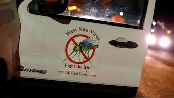 A vector control team vehicle displays a sign warning of West Nile Virus before the early morning spraying of a neighborhood due to increasing numbers of mosquitoes having tested positive for West Nile virus in San Diego, California, U.S. May 18, 2016. (Representative Photo, Credit: Reuters)