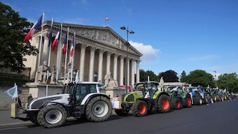 Tractors are parked outside the National Assembly as farmers protest regulations imposed on them, on Monday, in Paris. AP 