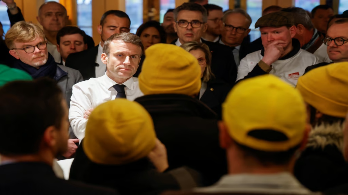 Members of the Coordination Rurale union confronts French President Emmanuel Macron. AFP Members of the Coordination Rurale union confronts French President Emmanuel Macron. AFP