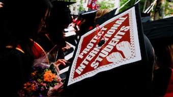 A student wears an academic cap reading "Protect International Students" during Harvard University's 374th Commencement Exercises in Cambridge, Massachusetts, US, May 29, 2025. File Image/Reuters