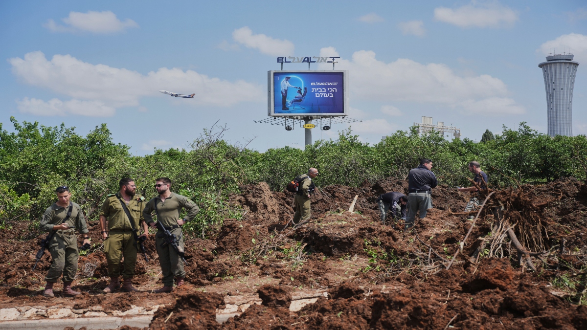 Israeli security forces inspect the site where the Israeli military said a projectile fired by Yemen's Houthi rebels landed in the area of Ben Gurion International Airport near Tel Aviv, Israel, on Sunday. AP Israeli security forces inspect the site where the Israeli military said a projectile fired by Yemen's Houthi rebels landed in the area of Ben Gurion International Airport near Tel Aviv, Israel, on Sunday. AP
