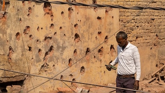 A man stands amid the debris on the roof of a damaged house, following Pakistan's military operation against India, in Rehari, Jammu, on May 10, 2025. Reuters