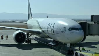 (File_ Ground staff work beside the state-run Pakistan International Airlines plane preparing to take-off for Paris after the airline resumes direct flights to Europe after EU lifted a four-year ban, at the Islamabad International Airport, in Islamabad, Pakistan on January 10, 2025. AP