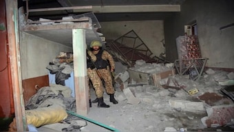 A Pakistani Army soldier examines a building damaged by missile attack carried out by Indian armed forces in PoK's Muzaffarabad. Image: AP Photo