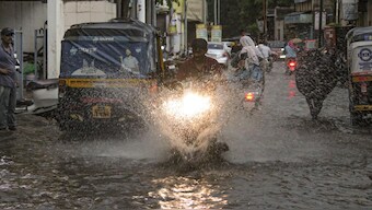 The monsoon arrived eight days early in Maharashtra, causing floods in Baramati and Indapur. Commuters amid rains, in Solapur, Maharashtra. (Photo: PI)