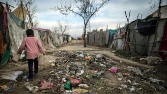 A boy carries empty jerrycans at a slum on the outskirts of Islamabad, Pakistan, March 10, 2015. File Image/Reuters