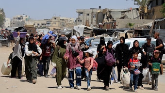 Palestinians make their way with belongings as they flee their homes after the Israeli military issued orders for evacuation from eastern Khan Younis, in the southern Gaza Strip, May 19, 2025. Reuters