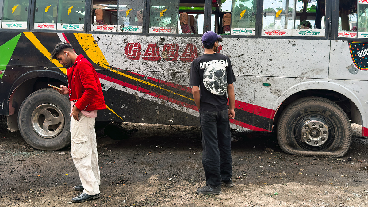 Local residents stand beside a damaged bus in the Indian-run town of Poonch on May 8, 2025. AFP Local residents stand beside a damaged bus in the Indian-run town of Poonch on May 8, 2025. AFP