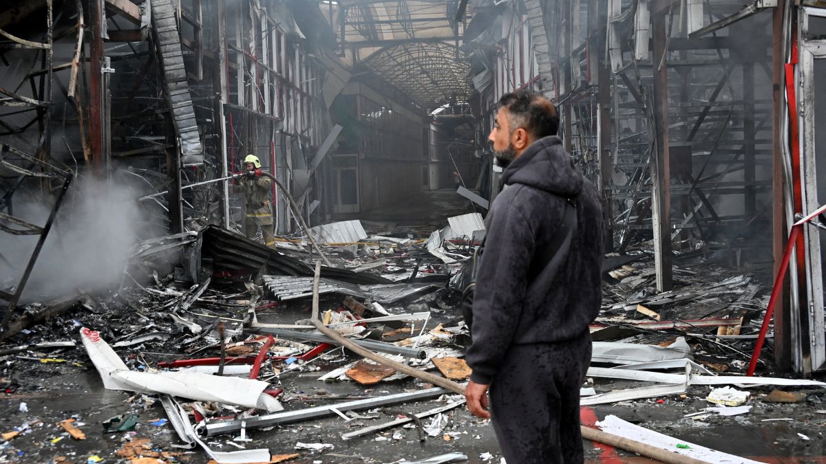 A man stands as a Ukrainian fireman finishes to put out a fire at the "Barabashovo" market following a drone strike in Kharkiv on May 6, 2025 amid the Russian invasion of Ukraine. Image- AFP A man stands as a Ukrainian fireman finishes to put out a fire at the "Barabashovo" market following a drone strike in Kharkiv on May 6, 2025 amid the Russian invasion of Ukraine. Image- AFP