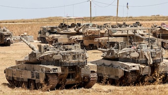 This picture taken from a position in southern Israel shows Israeli tanks deployed on the border with the Gaza Strip on May 17, 2025. AFP Photo