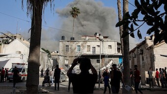 This picture taken from the grounds of the Ahli Arab Hospital, also known as the Maamadani (Baptist) Hospital, shows a cloud of smoke erupting following Israeli bombardment on a building in the Daraj neighbourhood of Gaza City on May 31, 2025. (AFP)