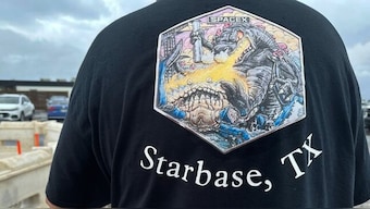 A man with the proposed new name for the town on his T-shirt is seen in Boca Chica, Texas, that would become Starbase, Texas. File Image/AP