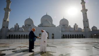 US President Donald Trump shakes hands with Yousif Al Obaidli, director of Sheikh Zayed Grand Mosque, as he tours the mosque grounds in Abu Dhabi, United Arab Emirates, on Thursday. Reuters
