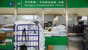A postman works on packages at the General Post Office in Hong Kong, on April 9, 2025. Reuters File