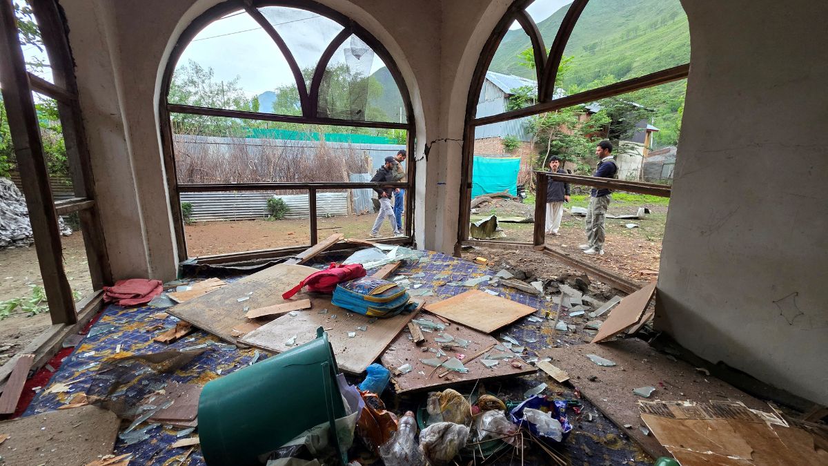 Men are seen through windowpanes of a residential house damaged by a cross-border shelling in Gingal village near the Line of Control (LoC) between India and Pakistan, in Kashmir's Baramulla district, May 9, 2025. Reuters Men are seen through windowpanes of a residential house damaged by a cross-border shelling in Gingal village near the Line of Control (LoC) between India and Pakistan, in Kashmir's Baramulla district, May 9, 2025. Reuters