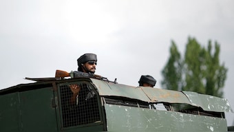 An Indian Army soldier looks out from an armoured vehicle on a highway leading to south Kashmir's Pahalgam, in Marhama village, in Kashmir. Reuters