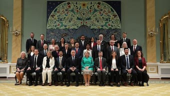 Canada's Prime Minister Mark Carney (center L), seated next to Governor General Mary Simon (ceneter R), poses for a group photo with the members of the Canadian cabinet following their swearing-in ceremony at Rideau Hall in Ottawa, Ontario, Canada, May 13, 2025. AFP