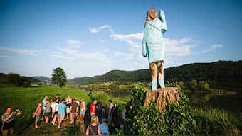 People gather around what conceptual artist Ales 'Maxi' Zupevc claims is the first ever monument of Melania Trump, set in the fields near the town of Sevnica, US First Lady’s hometown. AFP