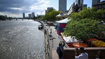 A woman poses for a picture on a bridge above the Main river in the centre of Frankfurt am Main, western Germany, on August 7, 2023. File Photo/AFP